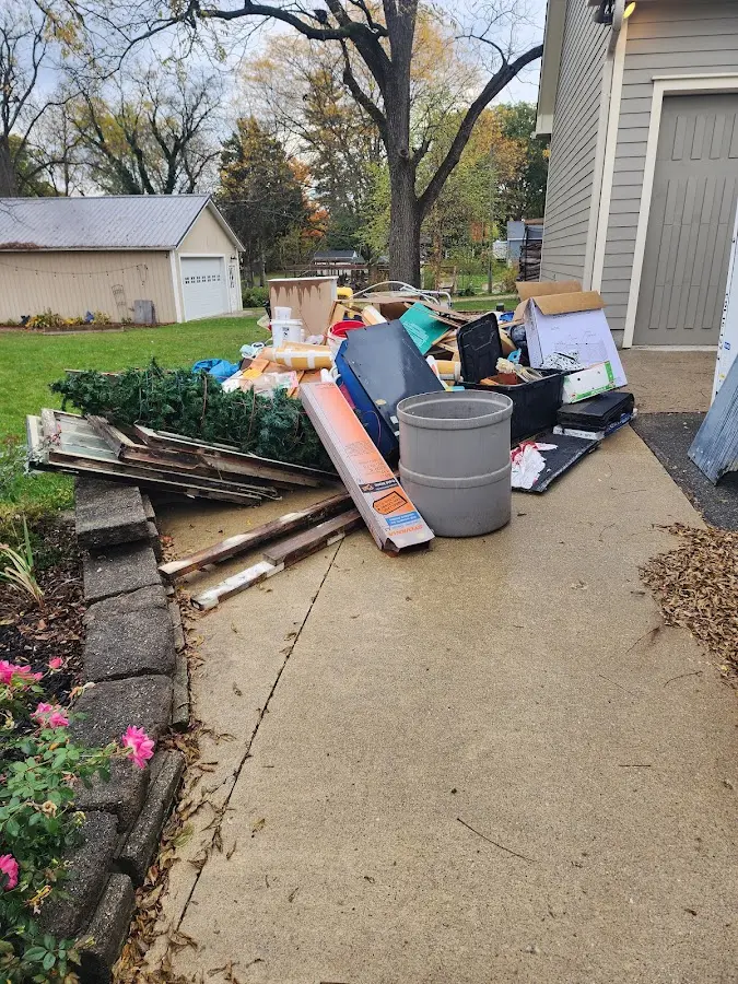 Dumpster being loaded with debris for 10 Yard Dumpster Rental in Petersburg